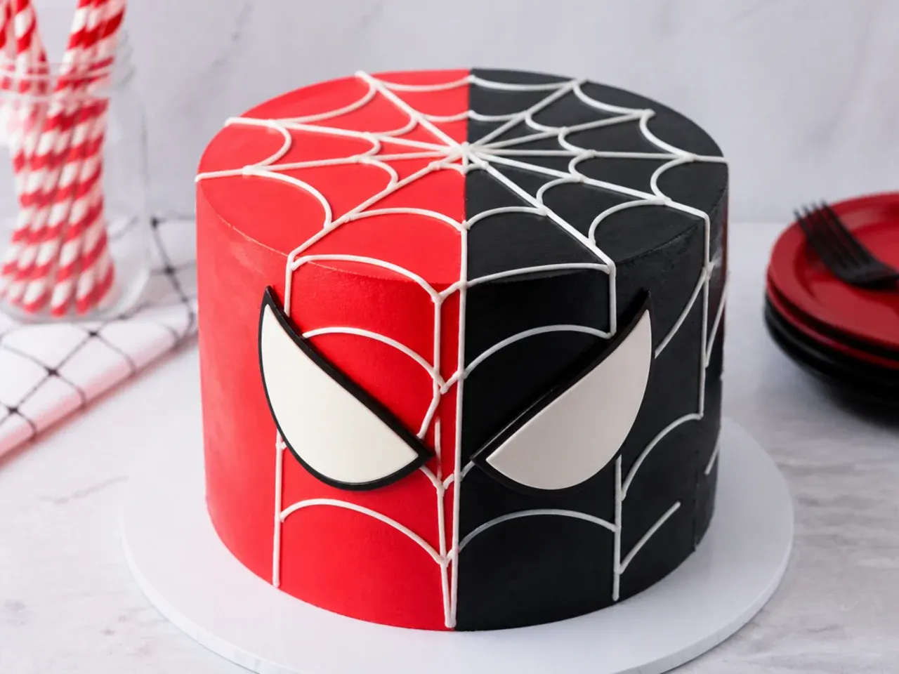 Bold split spiderman cake idea with half red half black buttercream and white web