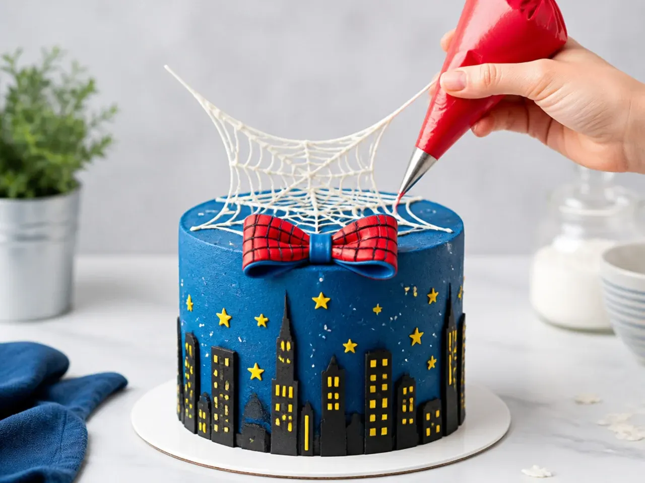 Creative gravity defying spiderman cake idea with piping bag pouring candy melt web