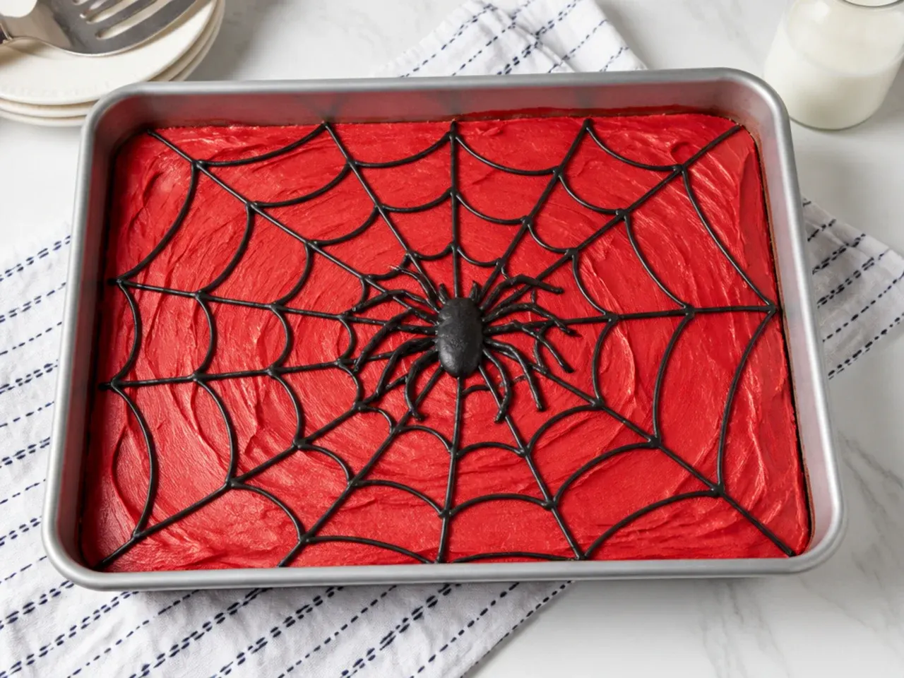 Easy no-fondant Spiderman sheet cake for boys decorated flat in the pan with black web