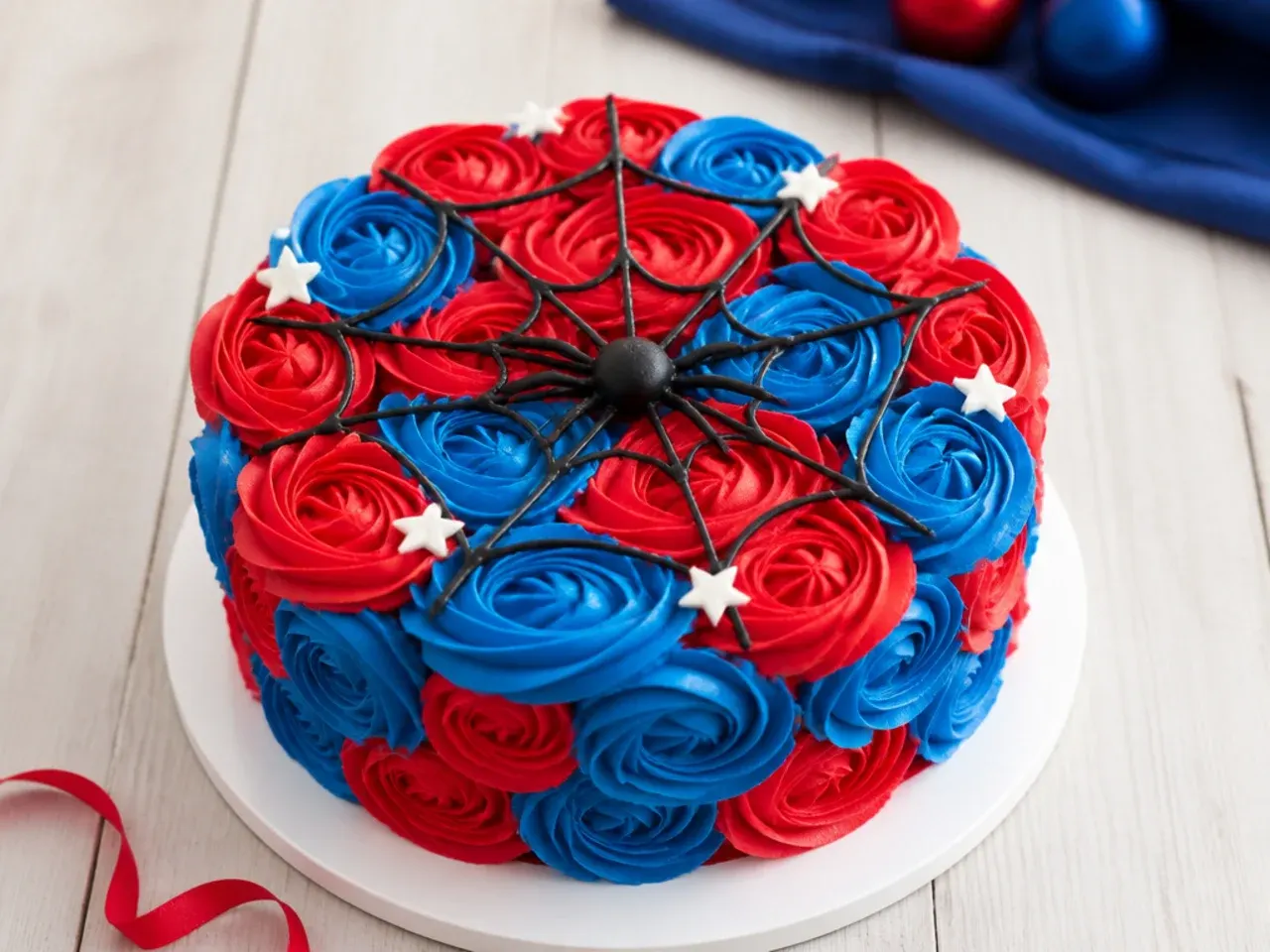 Effortless rosette Spiderman cake for boys with alternating red and blue buttercream swirls