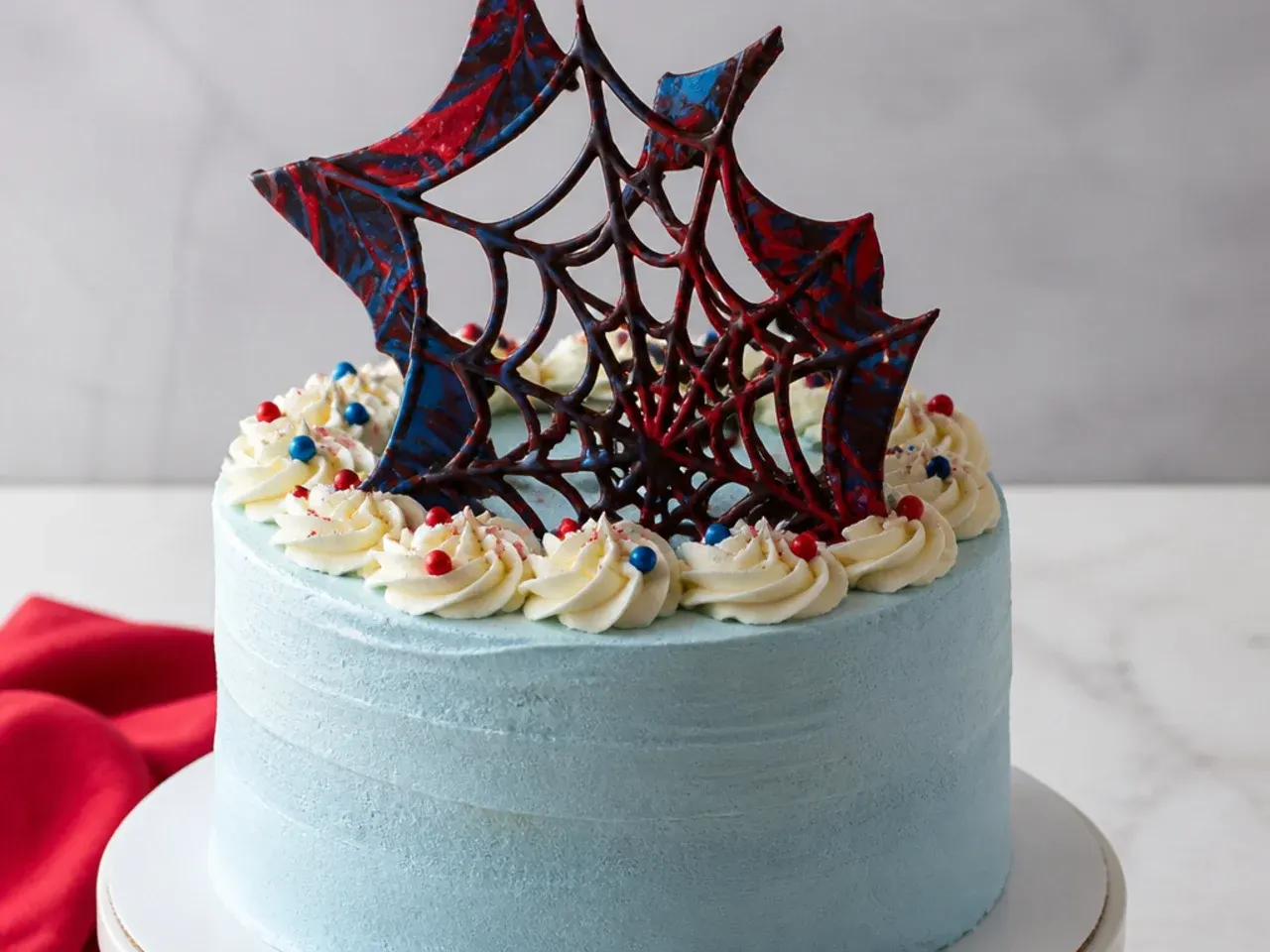Creative chocolate transfer web spiderman cake topper shard standing in buttercream
