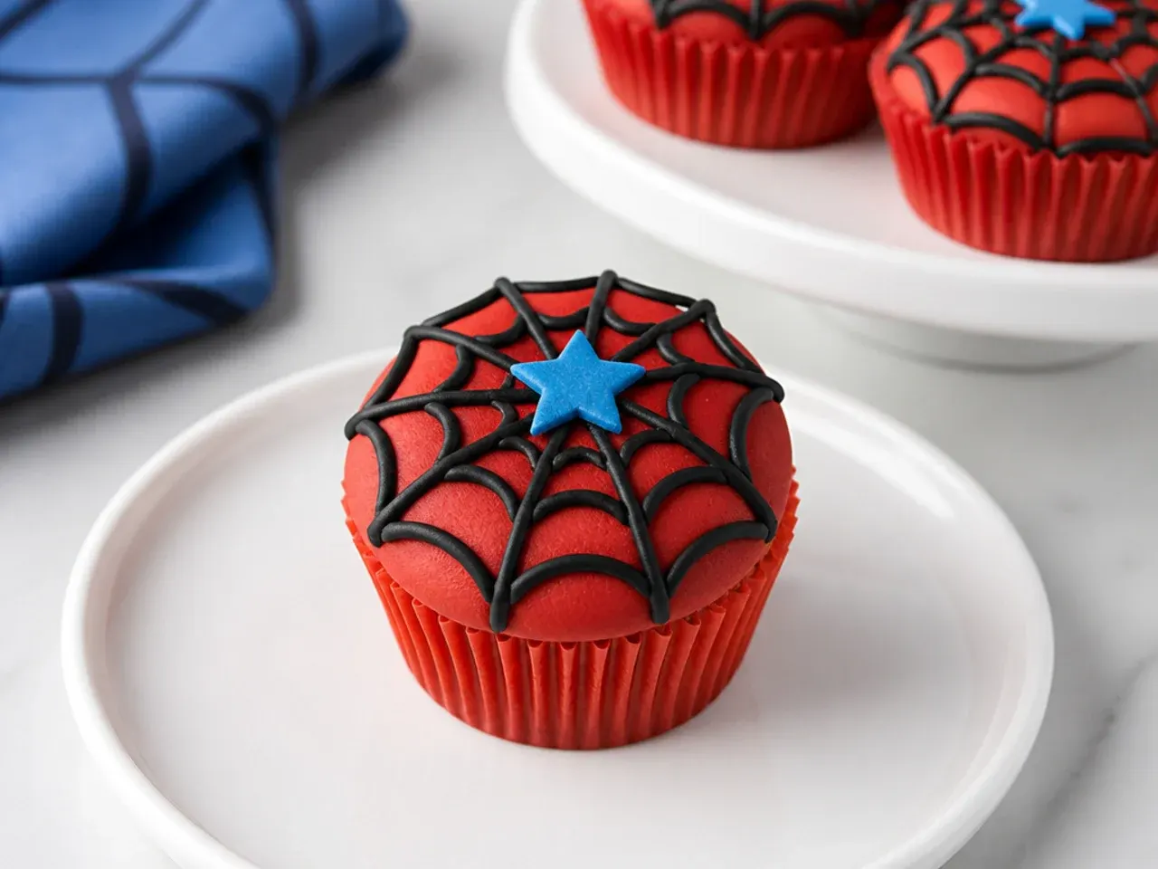 Minimal Spiderman cupcakes each topped with a single fondant star