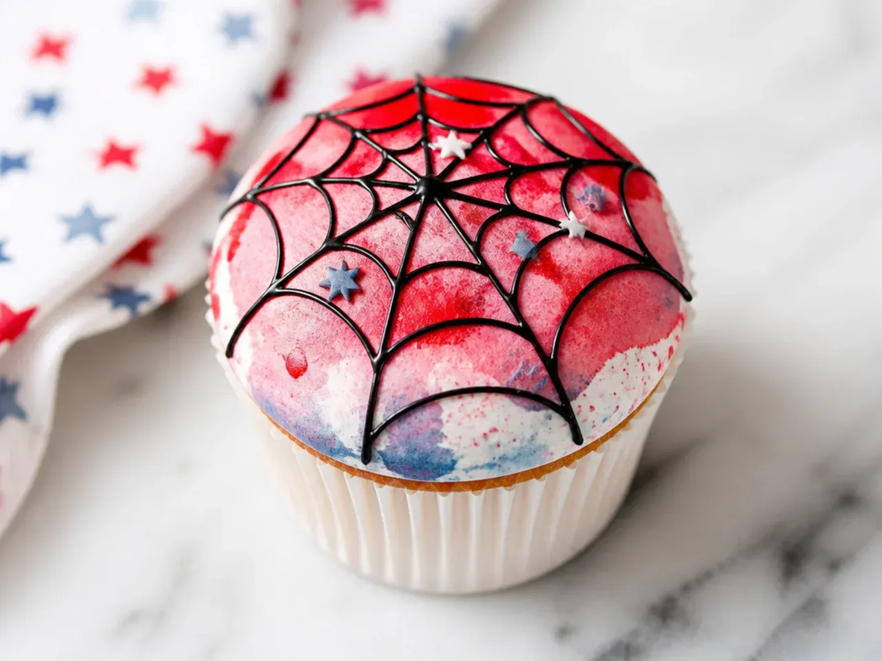 Delicate watercolor red Spiderman cupcakes with a faint painted web