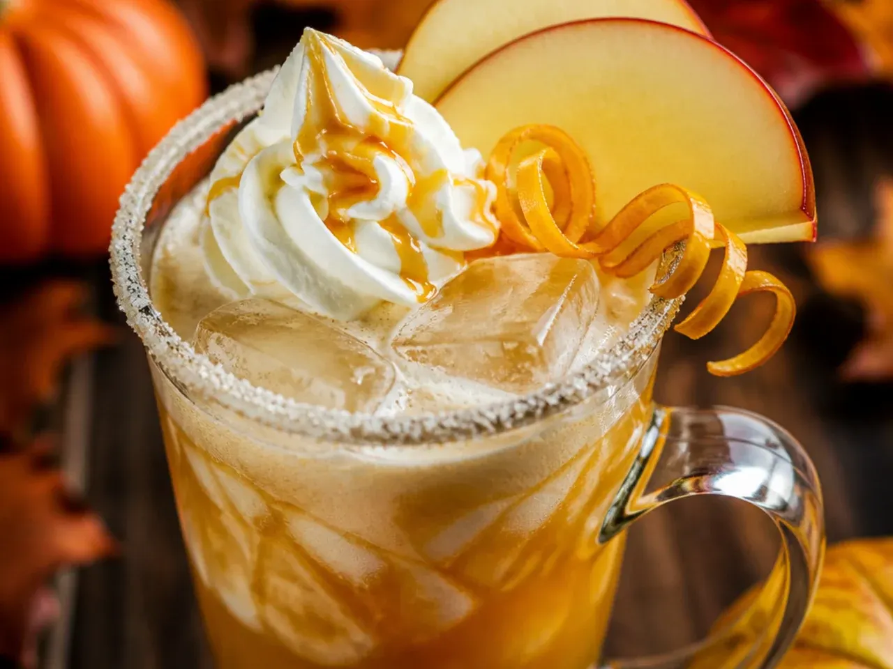 Creamy butterscotch apple float in a tall glass with vanilla ice cream and butterscotch drizzle