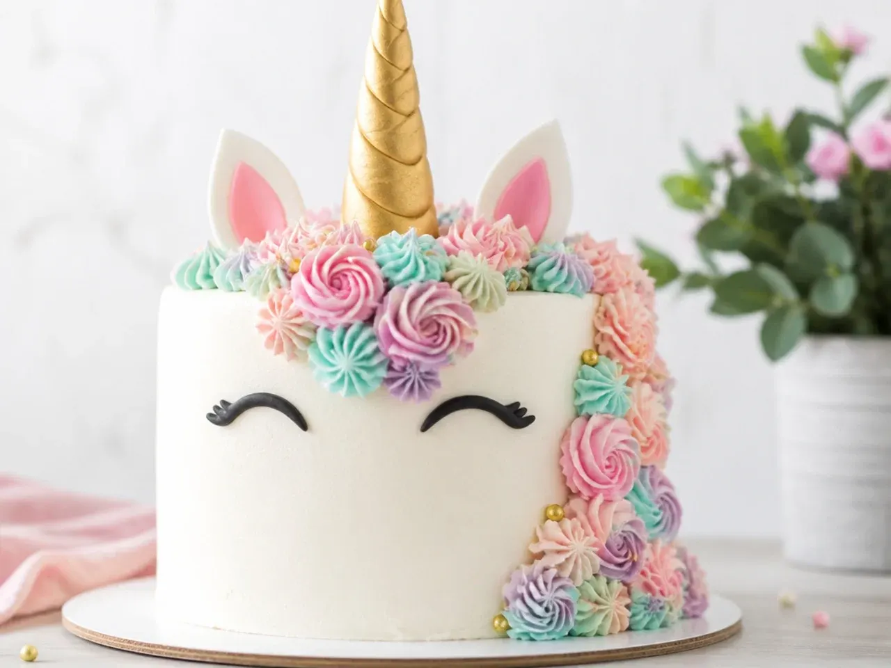 Delicate unicorn cake design with piped buttercream flower mane