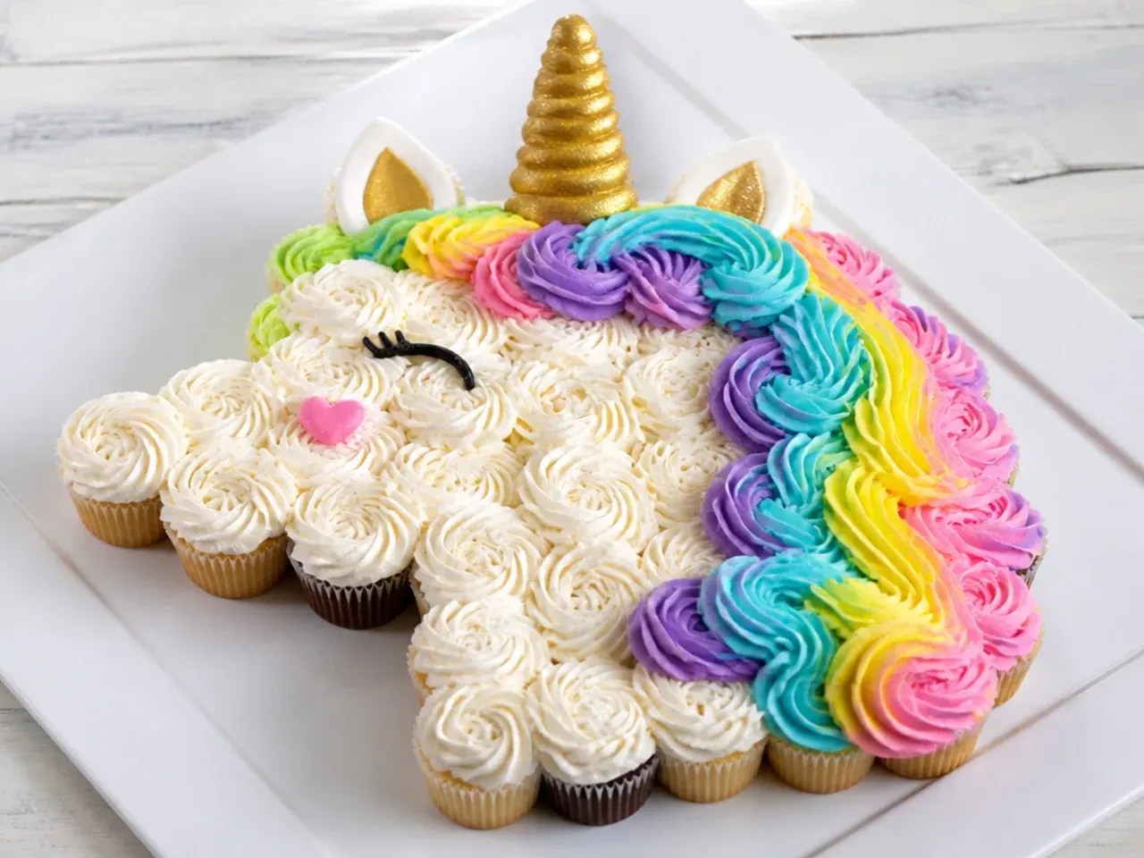 Pull-apart unicorn cupcake cake shaped like a unicorn head