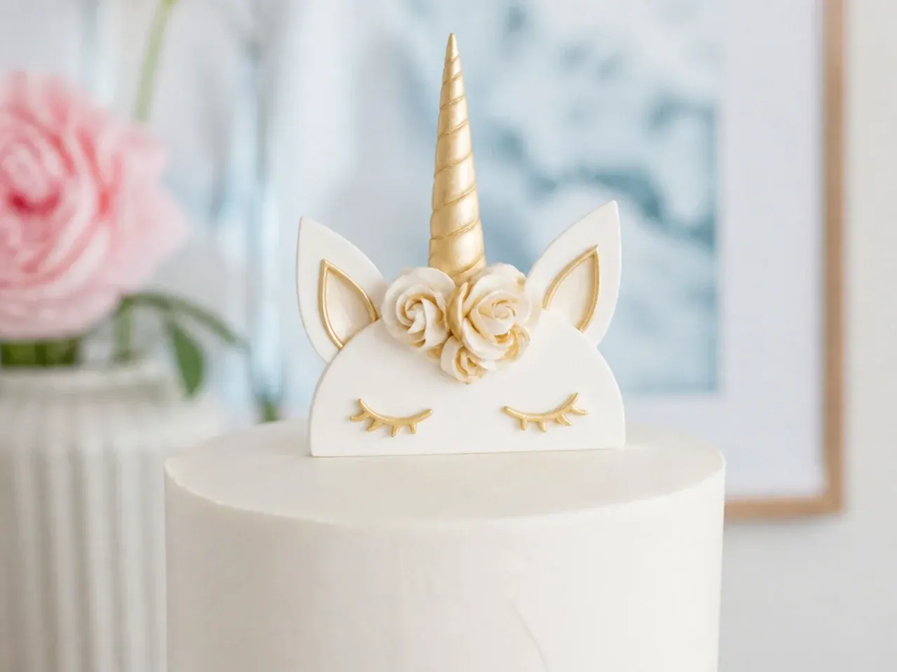 Elegant white and gold minimalist unicorn cake topper with a slim horn