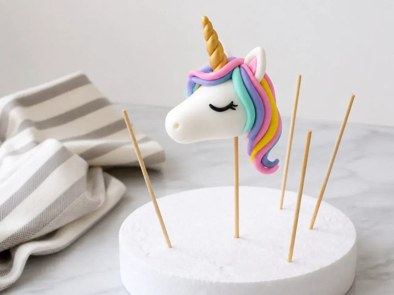 Tips for making a unicorn cake topper easier with fondant drying upright on skewers