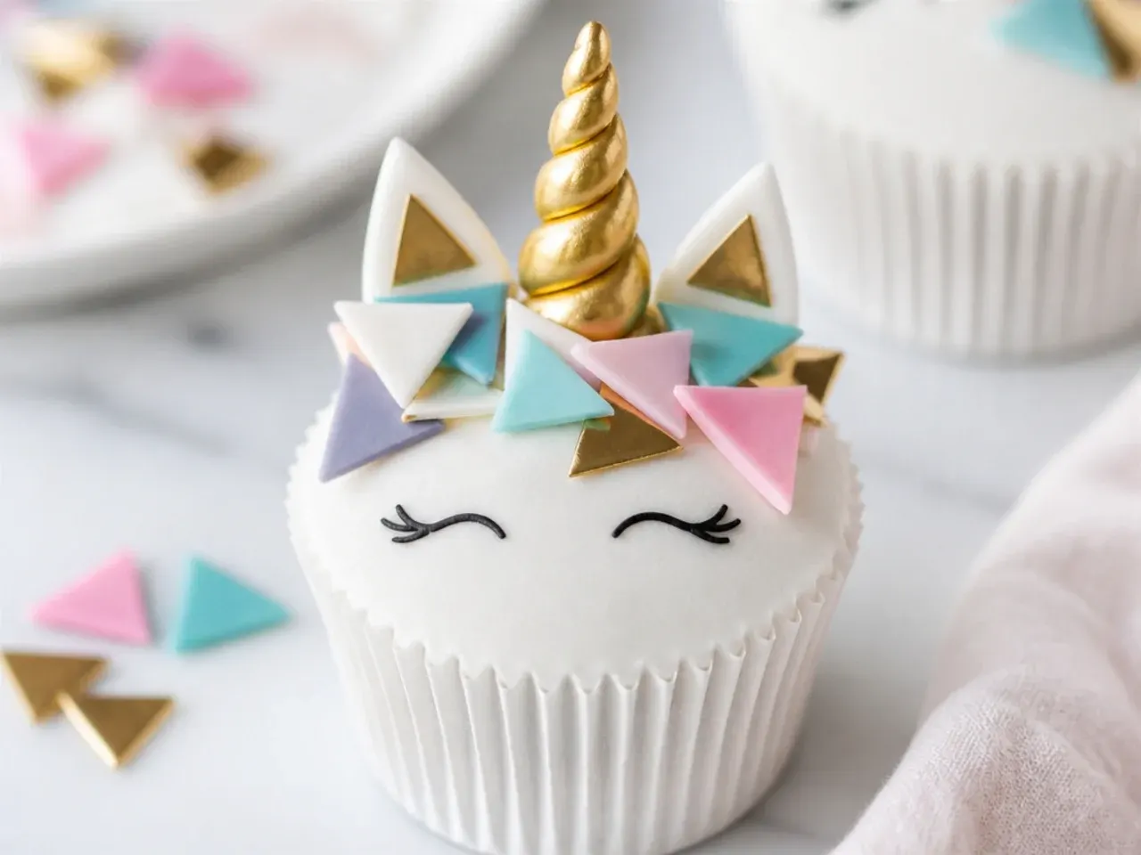 Modern geometric unicorn cupcakes with flat buttercream and metallic triangle sprinkles