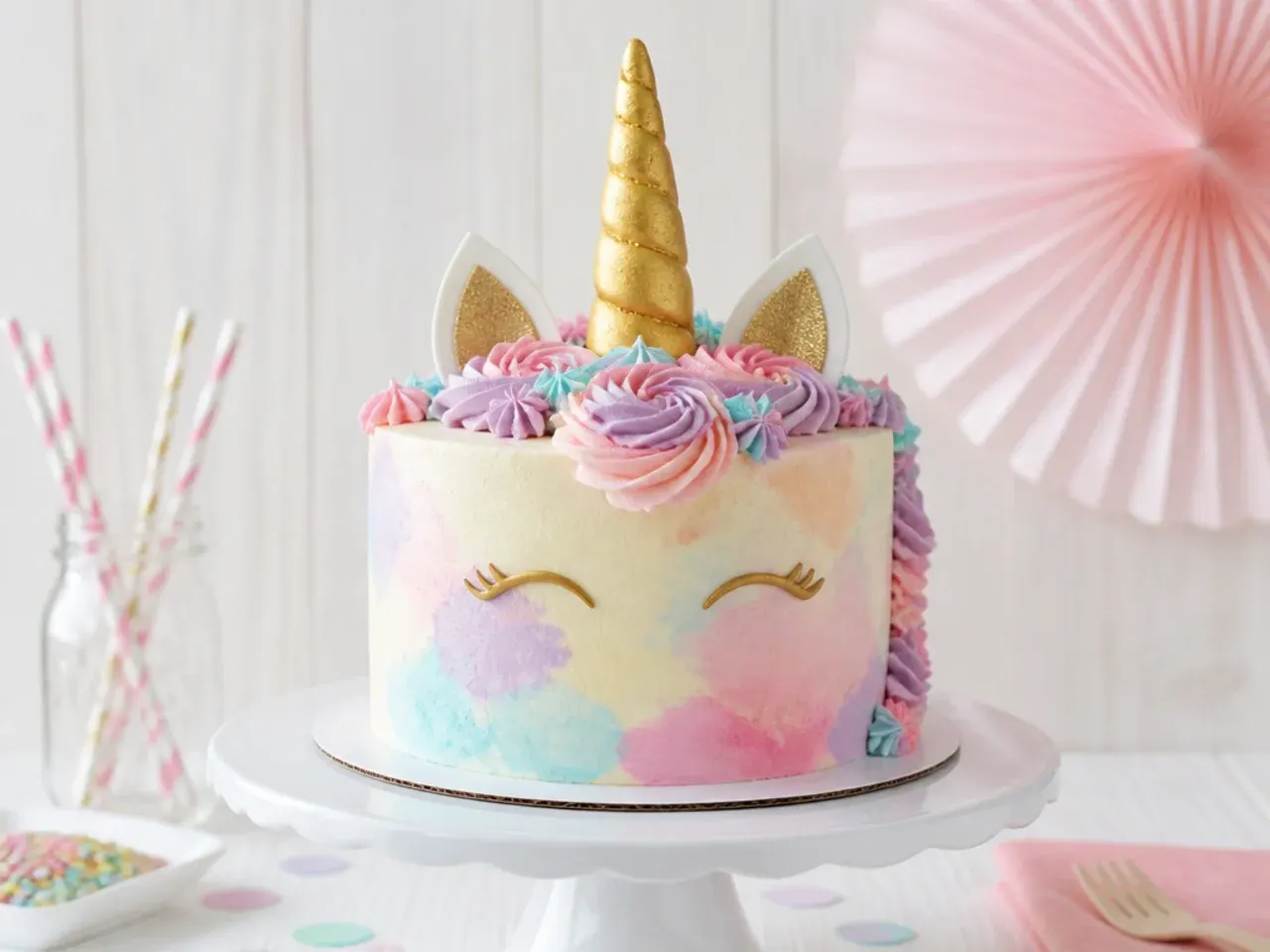 Delicate watercolor buttercream unicorn smash cake in soft pastel washes